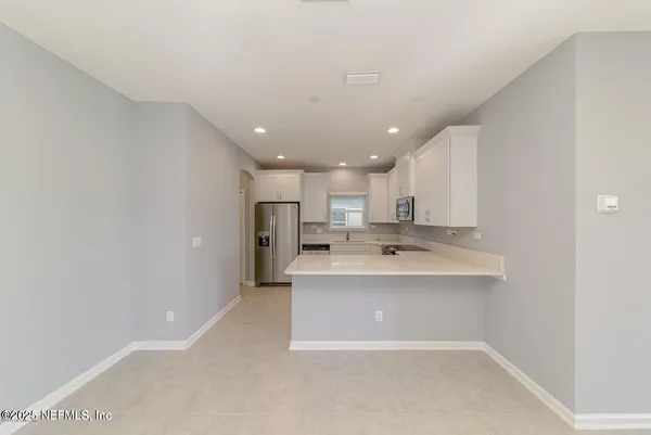 a view of a kitchen with a sink stainless steel appliances and cabinets