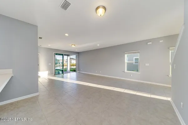 an empty room with windows and entrance