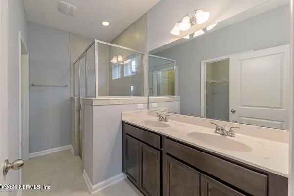 a bathroom with a sink double vanity and a mirror