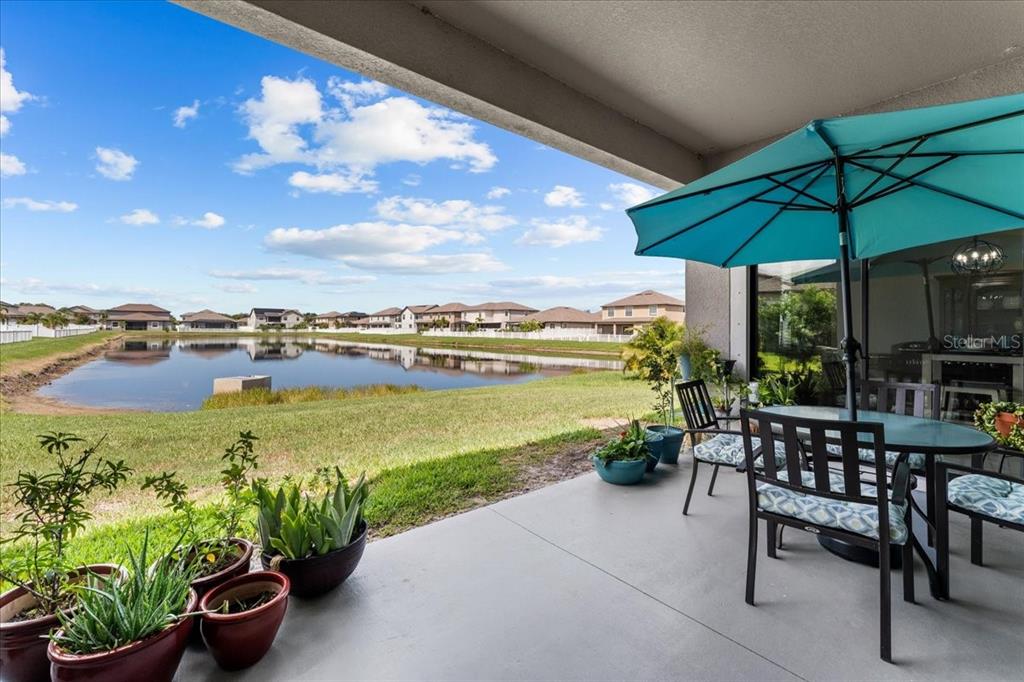 13443 White Sapphire Road Riverview, FL 33579 - Photo 2 of 47 a view of a patio with a table and chairs under an umbrella