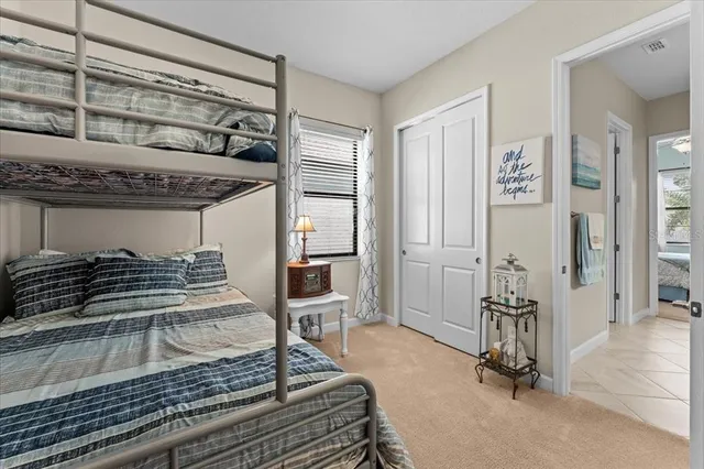 a bedroom with bed and a book shelf