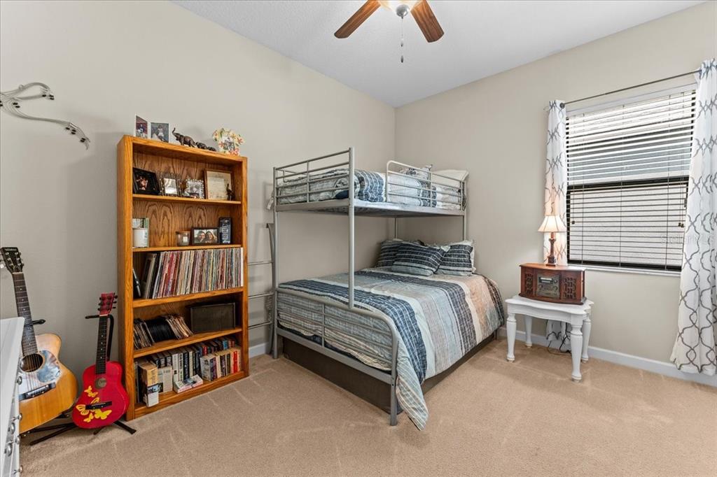 13443 White Sapphire Road Riverview, FL 33579 - Photo 27 of 47 a bedroom with bed and a book shelf