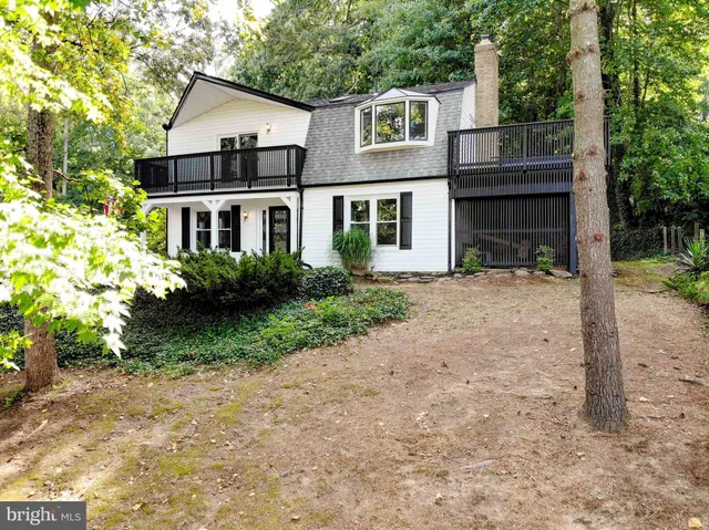a view of a house with a yard and potted plants