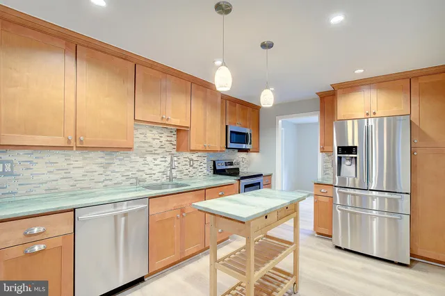 a kitchen with granite countertop a sink and a stove