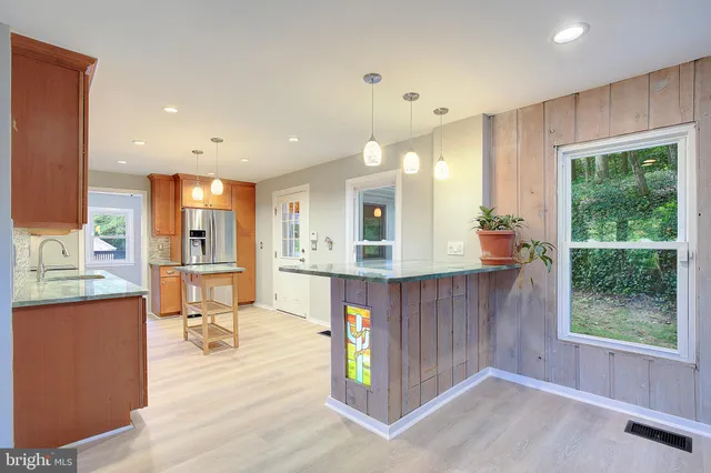 a view of an empty room with a fireplace and a window