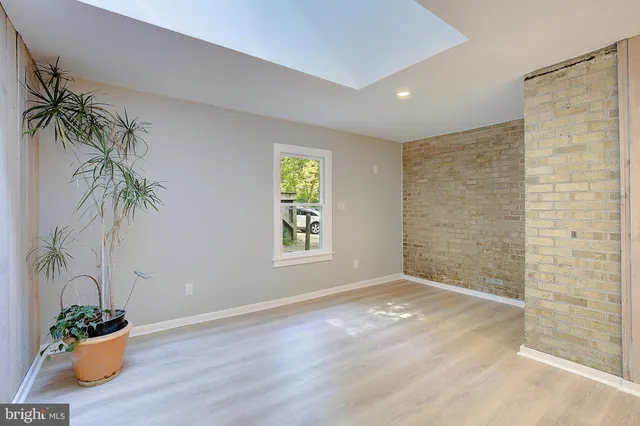 a view of a room with wooden floor and windows