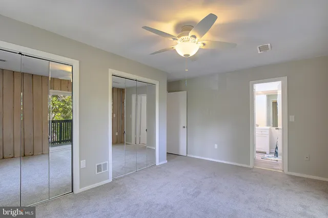 a view of an entryway with wooden floor and door