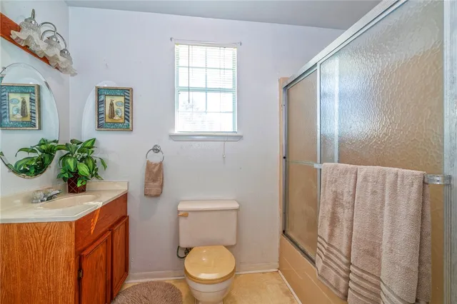 a white toilet sitting next to a bathroom sink