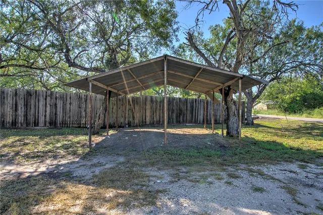 a backyard of a house with table and chairs