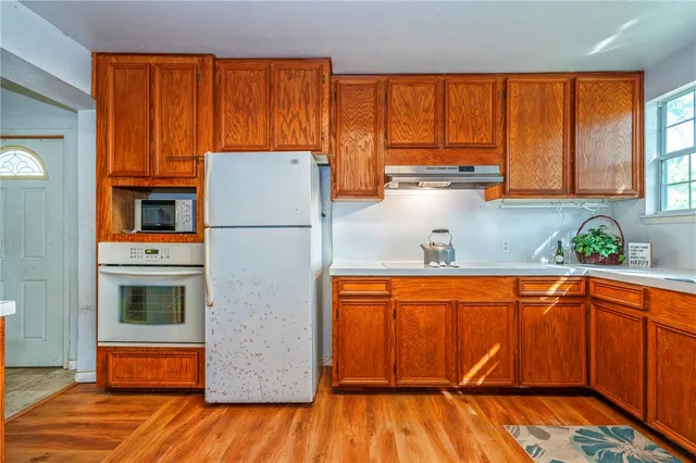 a white refrigerator freezer sitting inside of a kitchen