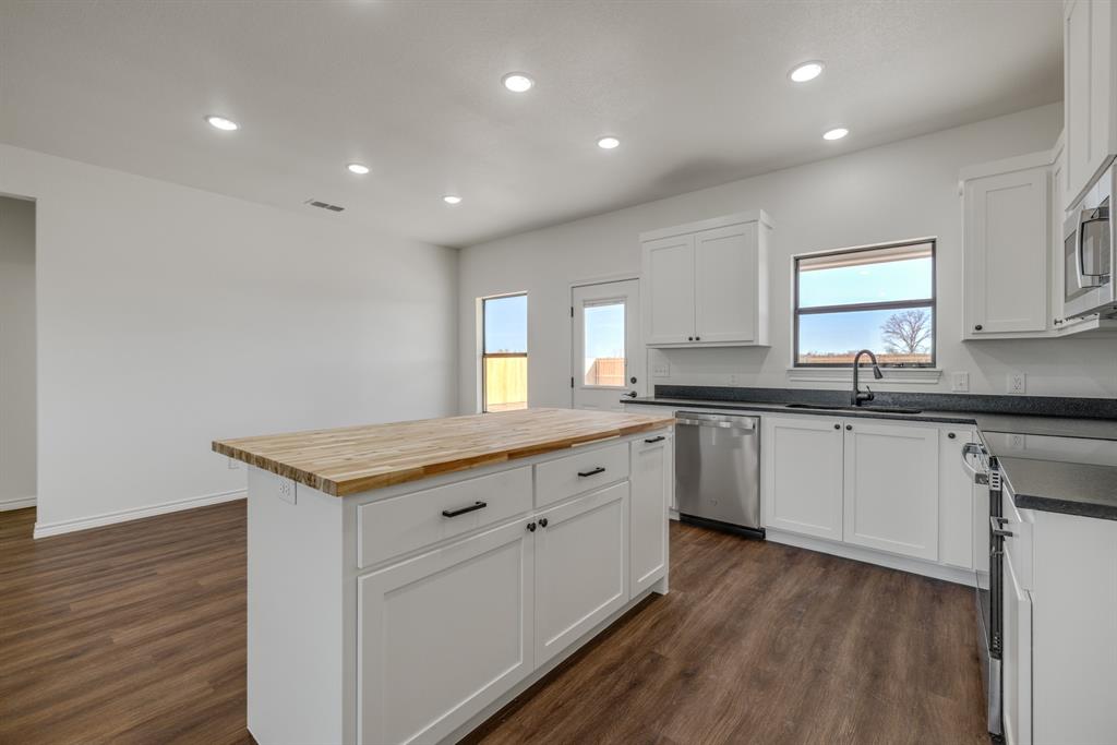 900 Ruger Drive Clyde, TX 79510 - Photo 5 of 11 a kitchen with granite countertop a sink and cabinets
