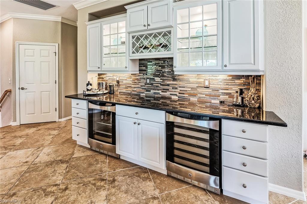 9107 Napoli Court, Unit 201 Naples, FL 34113 - Photo 13 of 35 a kitchen with stainless steel appliances granite countertop a stove and a sink