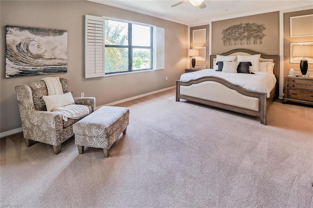 9107 Napoli Court, Unit 201 Naples, FL 34113 - Photo 15 of 35 a spacious bedroom with a bed and a couch