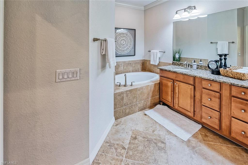 9107 Napoli Court, Unit 201 Naples, FL 34113 - Photo 17 of 35 a spacious bathroom with a tub sink and mirror