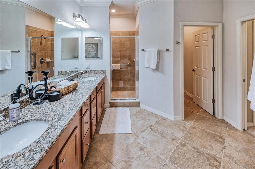 9107 Napoli Court, Unit 201 Naples, FL 34113 - Photo 18 of 35 a kitchen with granite countertop a sink stove and refrigerator