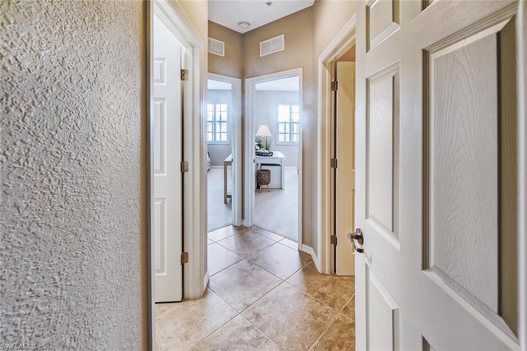 9107 Napoli Court, Unit 201 Naples, FL 34113 - Photo 19 of 35 a view of a bathroom with a glass door