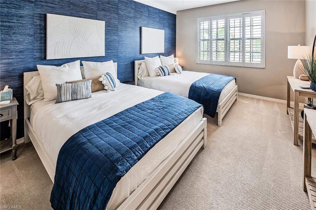 9107 Napoli Court, Unit 201 Naples, FL 34113 - Photo 23 of 35 a bed sitting in a bedroom next to a window