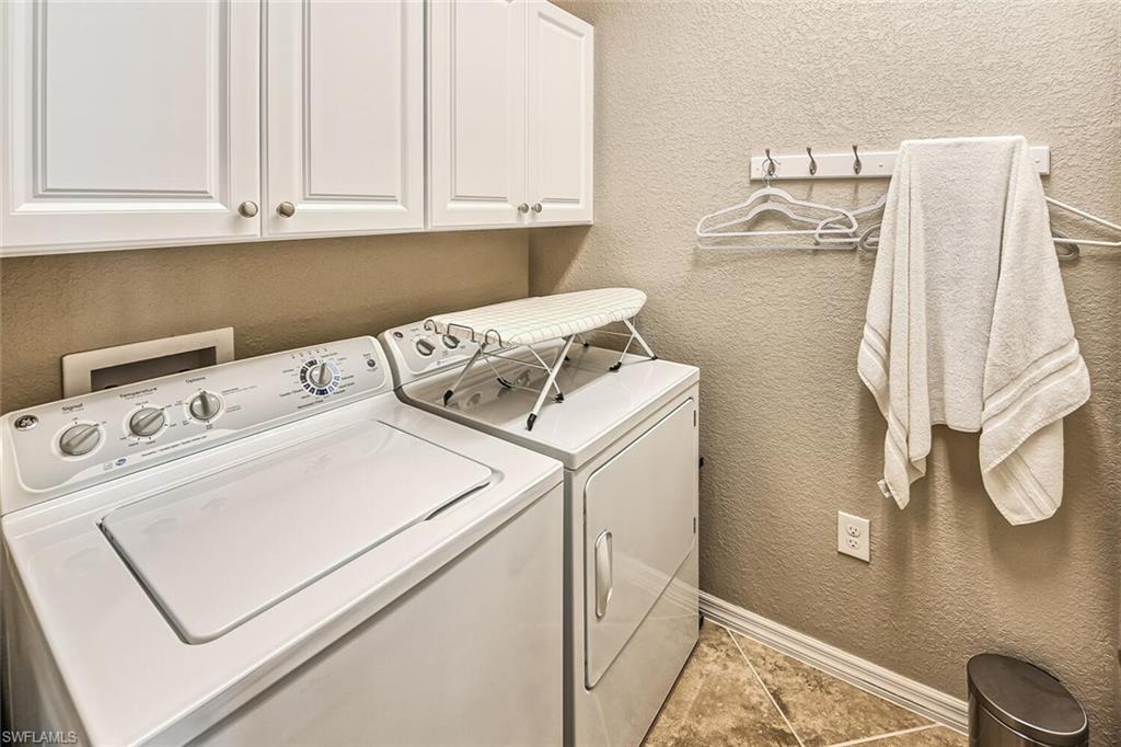 9107 Napoli Court, Unit 201 Naples, FL 34113 - Photo 25 of 35 a utility room with dryer and washer
