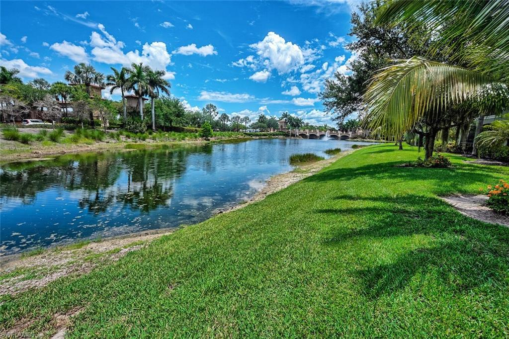 9107 Napoli Court, Unit 201 Naples, FL 34113 - Photo 27 of 35 a view of a lake with a yard