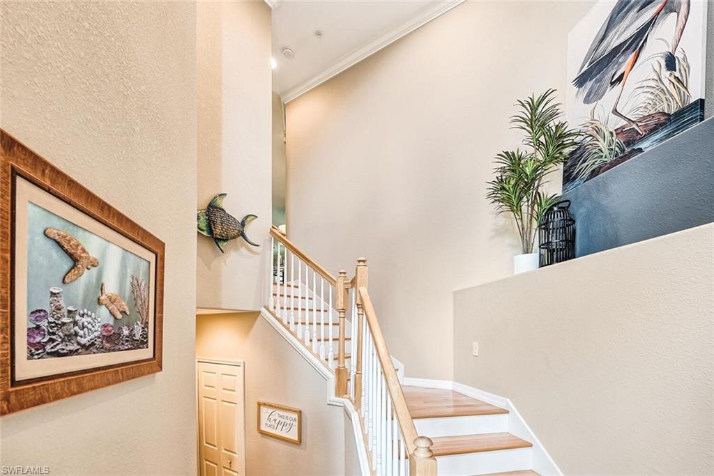9107 Napoli Court, Unit 201 Naples, FL 34113 - Photo 6 of 35 a view of a hallway with paintings on the wall