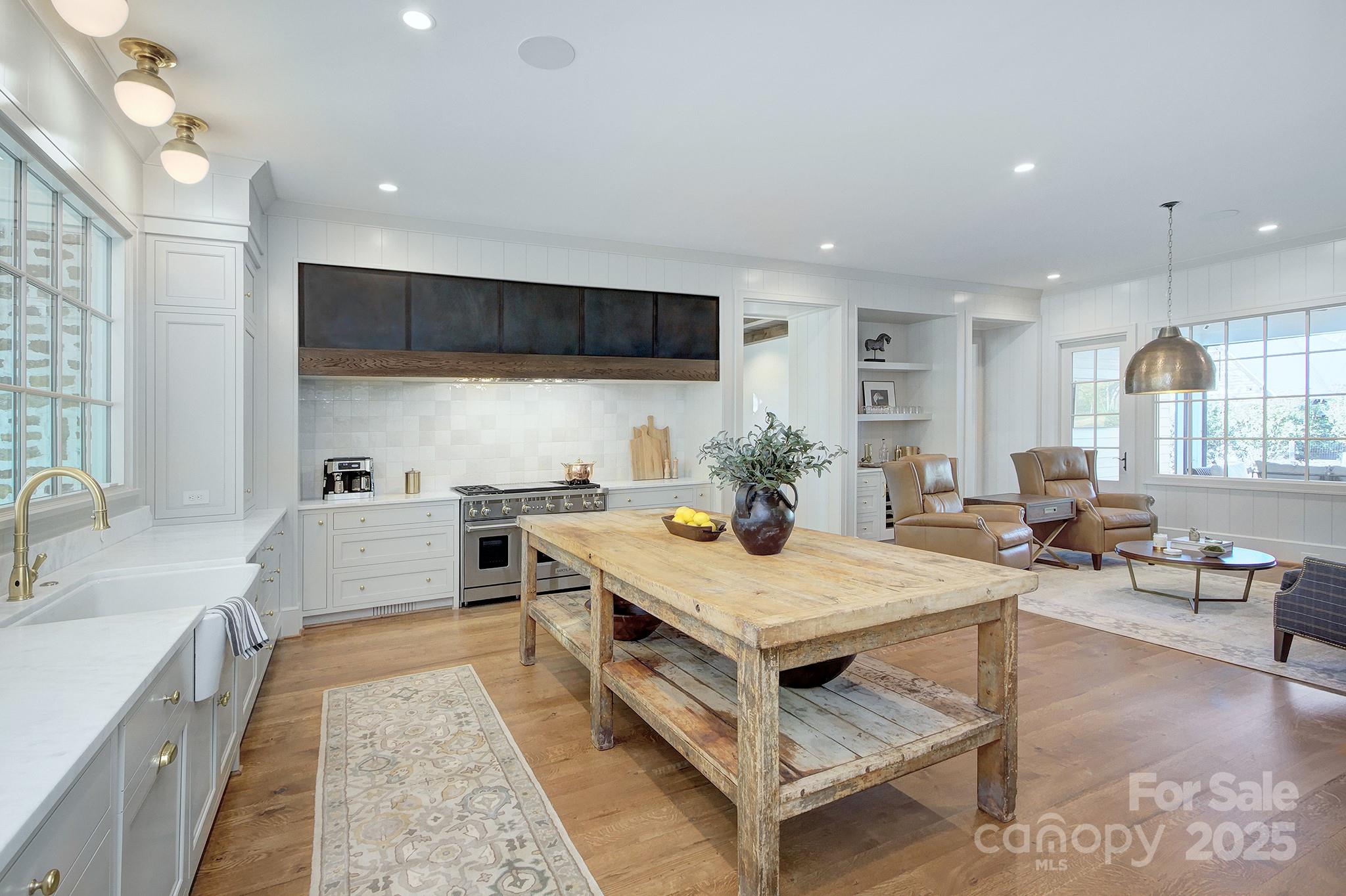 2270 New Gray Rock Road Fort Mill, SC 29708 - Photo 5 of 39 a large kitchen with kitchen island a stove a sink a dining table and chairs