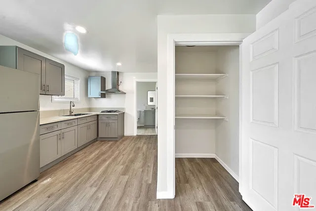 a kitchen with white cabinets and white appliances