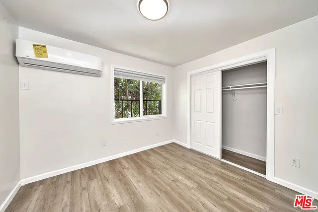 a view of a room with wooden floor and entryway
