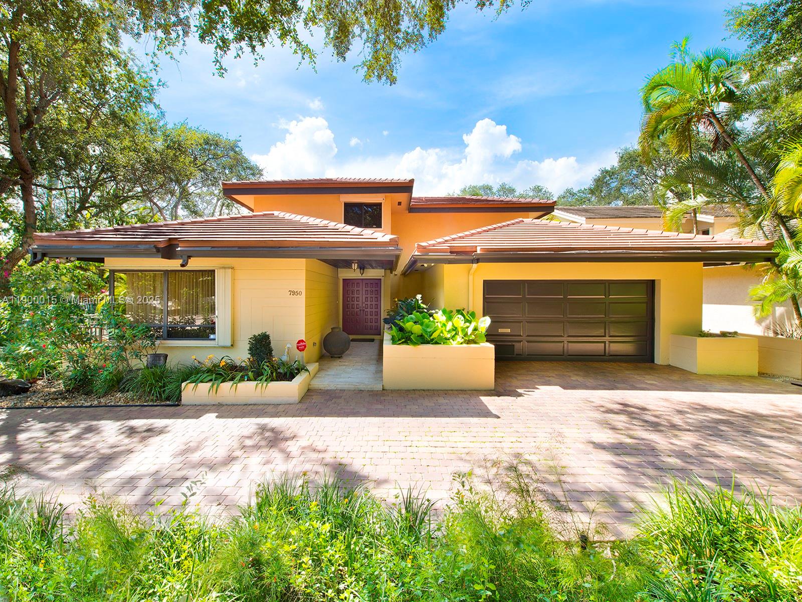 7950 Old Cutler Road Coral Gables, FL 33143 - Photo 1 of 30 a front view of a house with a yard and potted plants