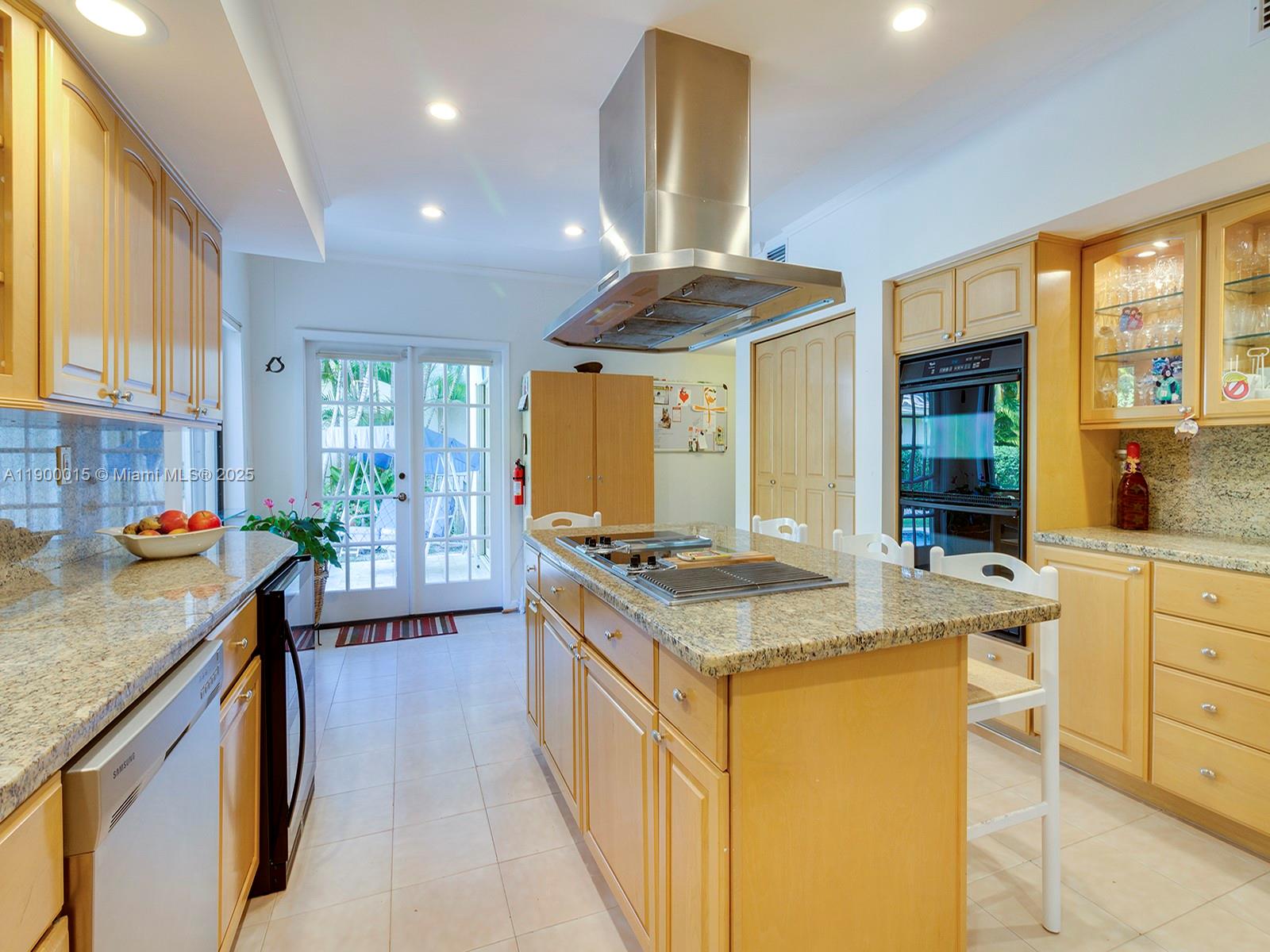 7950 Old Cutler Road Coral Gables, FL 33143 - Photo 11 of 30 a kitchen with a stove a sink a counter top space and living room view