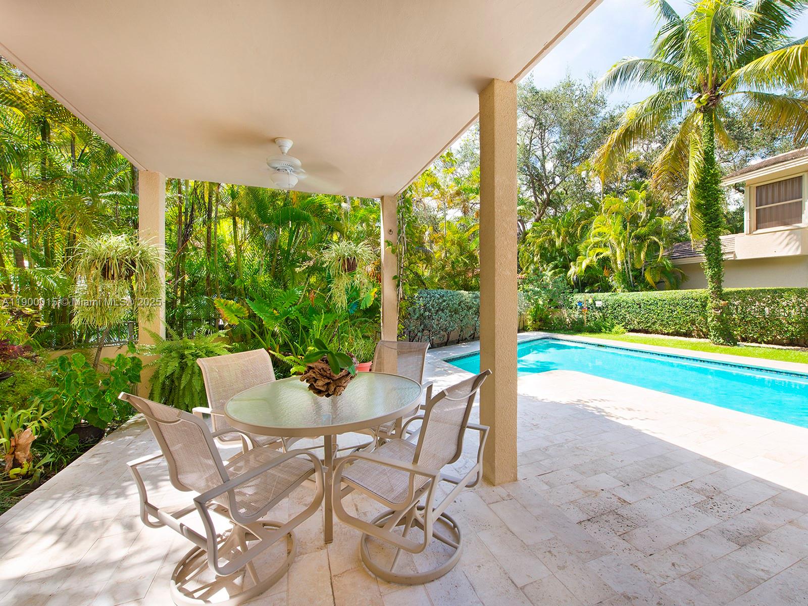 7950 Old Cutler Road Coral Gables, FL 33143 - Photo 13 of 30 a patio with yard glass top table and chairs
