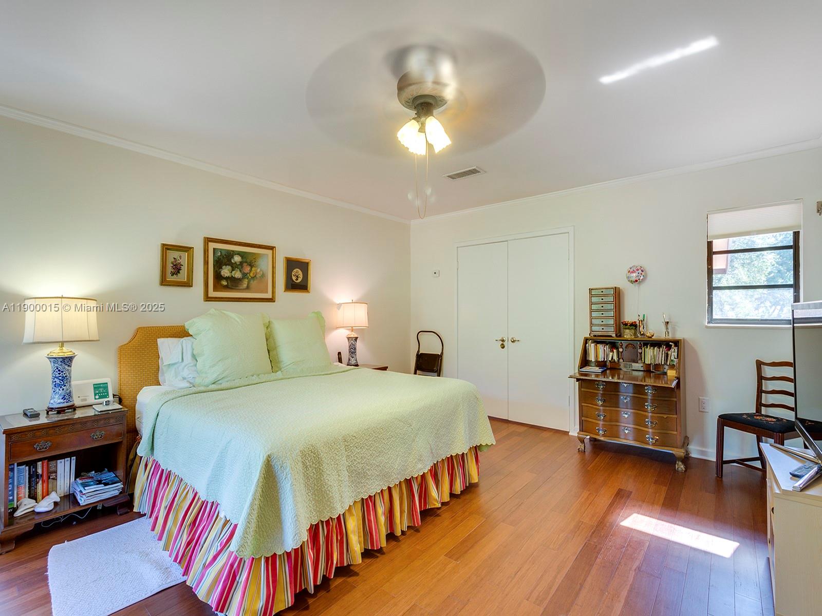 7950 Old Cutler Road Coral Gables, FL 33143 - Photo 17 of 30 a bedroom with a bed and wooden floor