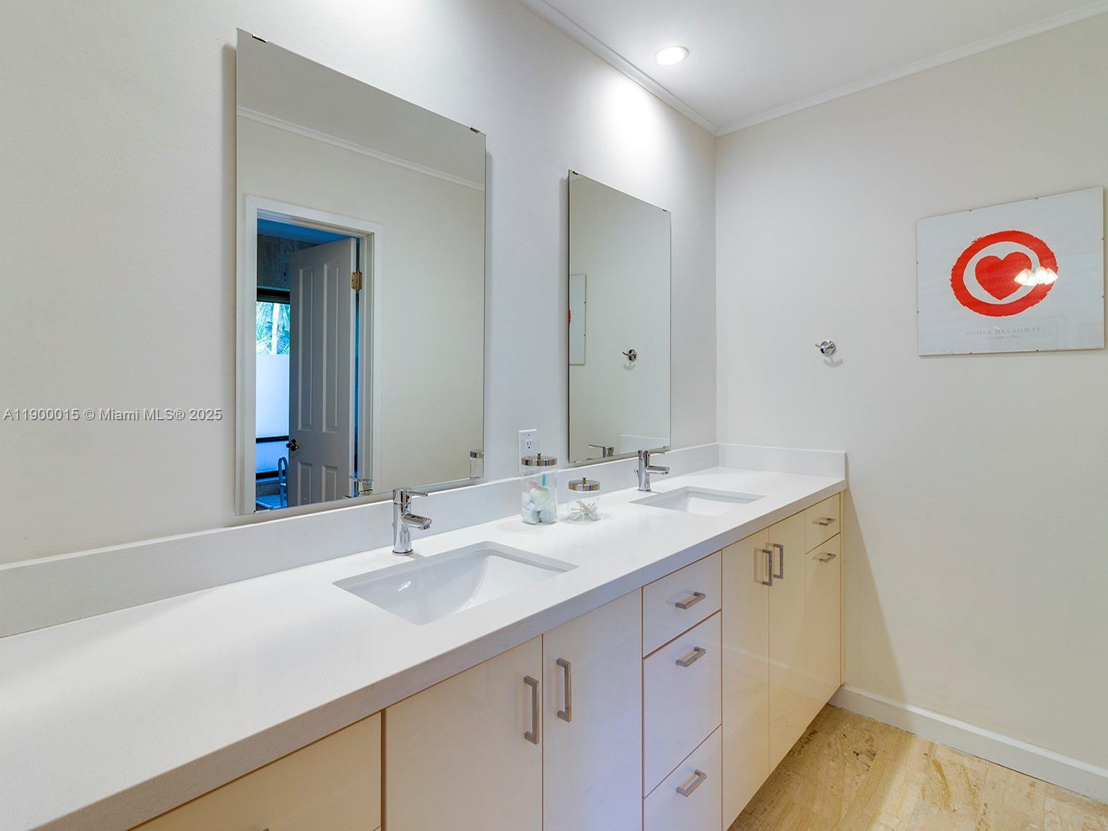 7950 Old Cutler Road Coral Gables, FL 33143 - Photo 21 of 30 a bathroom with a sink and a mirror