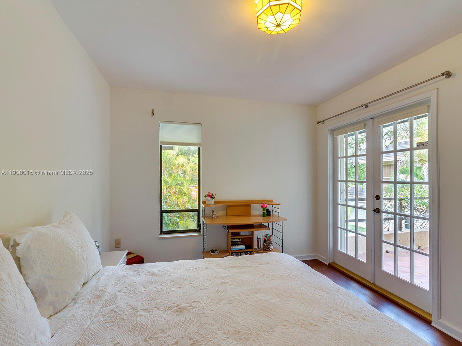 7950 Old Cutler Road Coral Gables, FL 33143 - Photo 23 of 30 a bedroom with a bed and a window