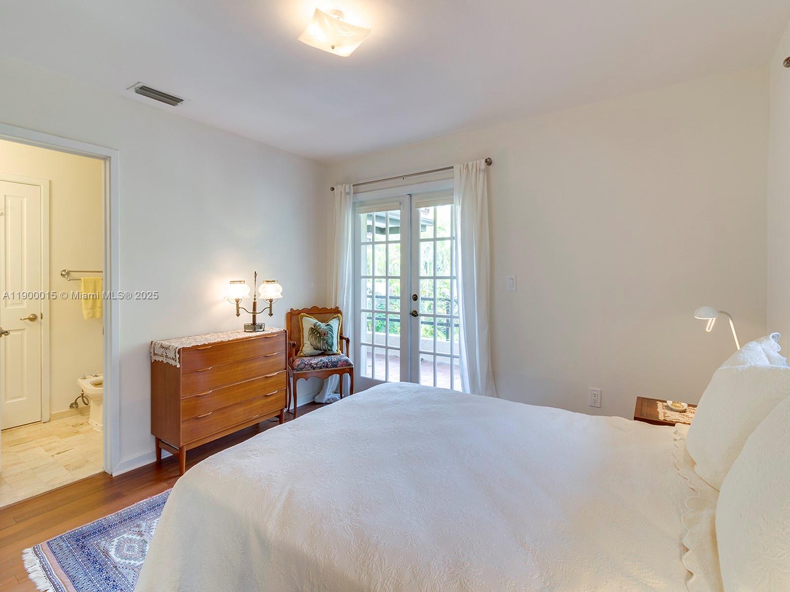 7950 Old Cutler Road Coral Gables, FL 33143 - Photo 27 of 30 a bedroom with a bed dresser and a window