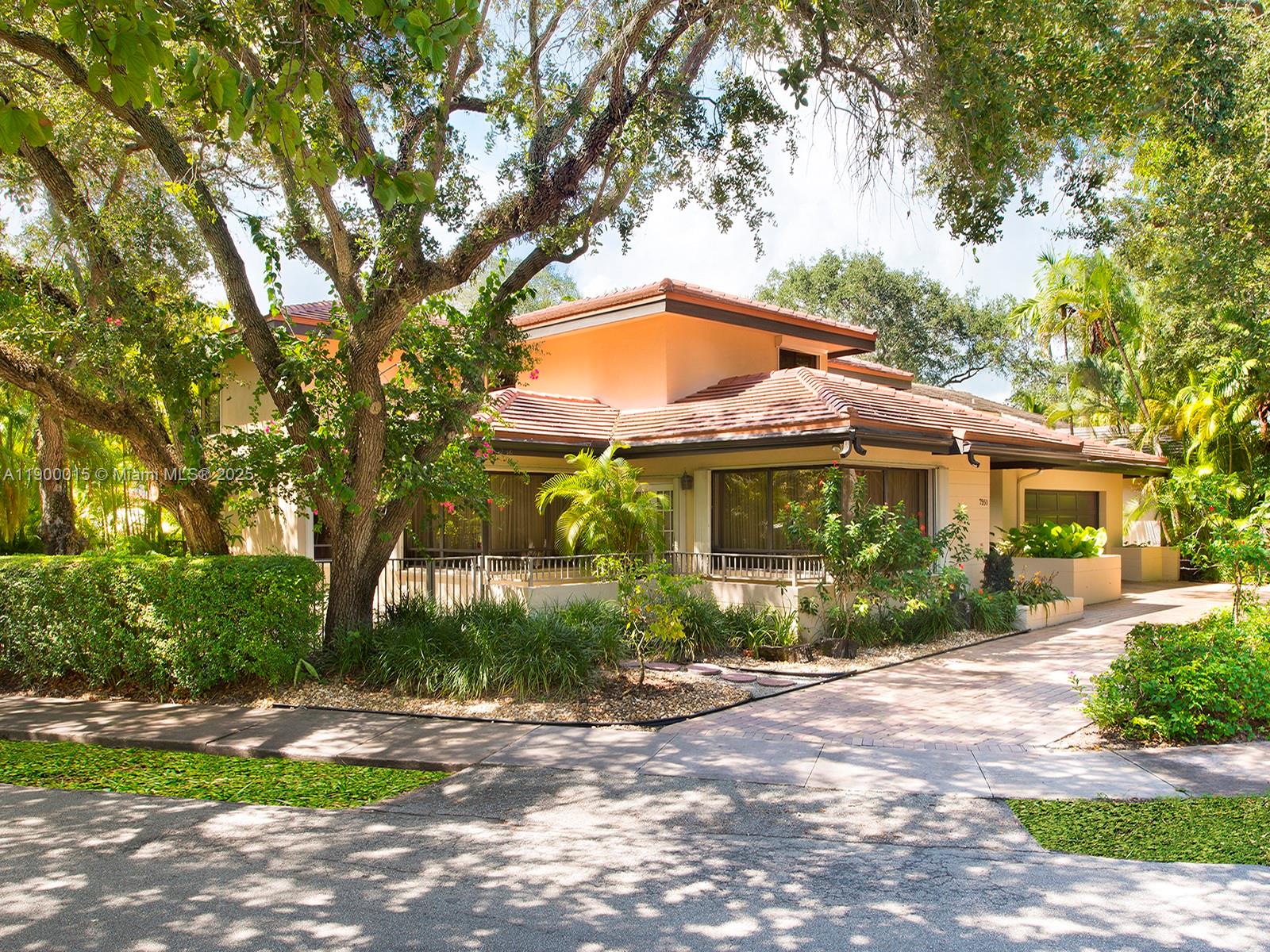 7950 Old Cutler Road Coral Gables, FL 33143 - Photo 29 of 30 a view of house in front of a yard with potted plants and large trees