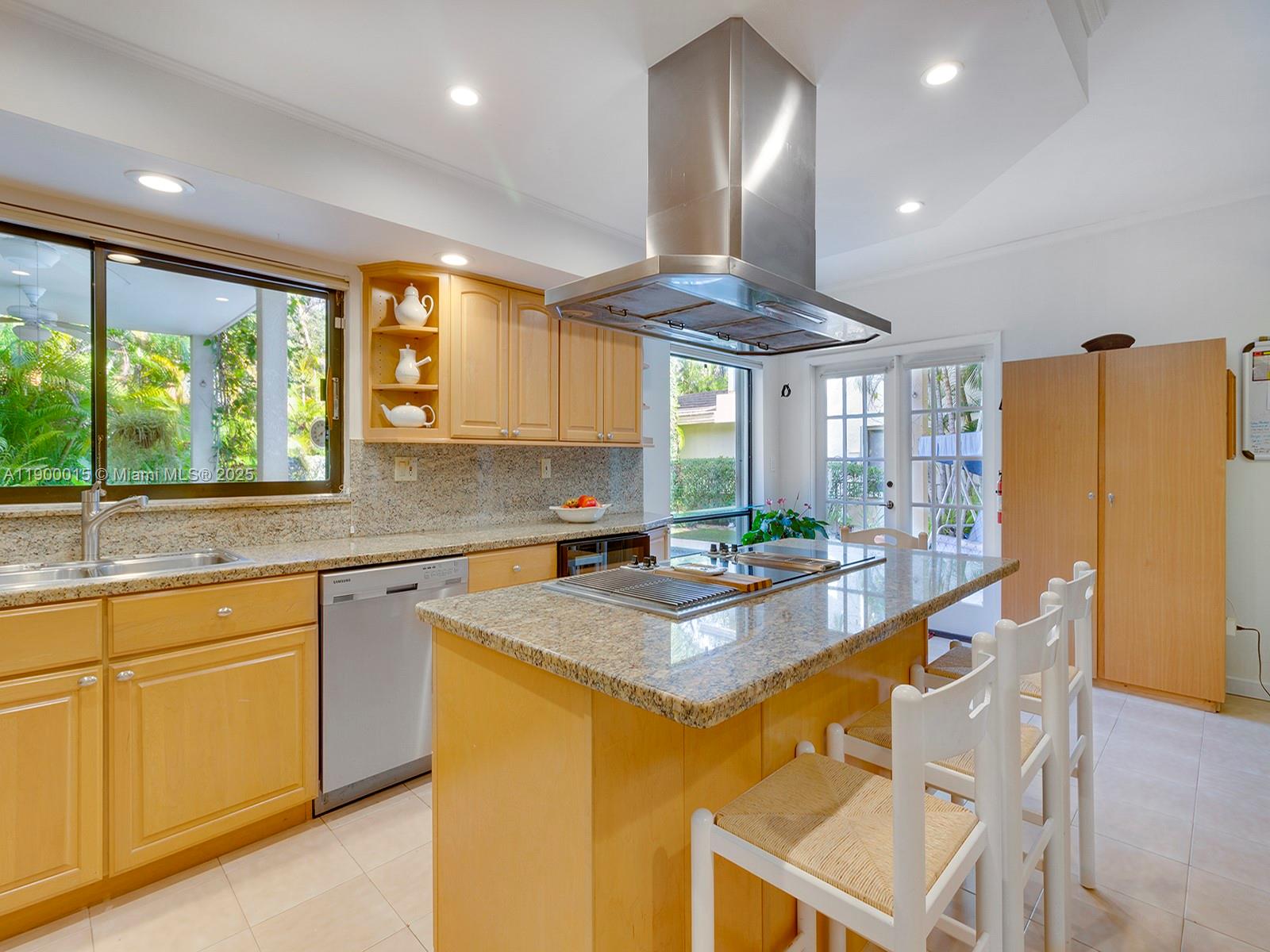7950 Old Cutler Road Coral Gables, FL 33143 - Photo 10 of 30 a kitchen with stainless steel appliances granite countertop a stove a refrigerator a sink dishwasher and white cabinets with wooden floor