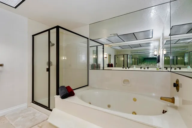 a bathroom with a tub and shower