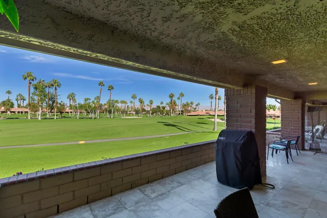 a view of a chairs and table in patio