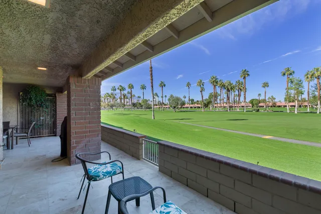 a patio with water view fountain with outdoor seating