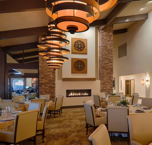 a dining room with furniture and wooden floor