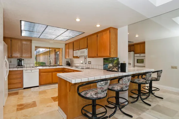 a kitchen with a table chairs sink and cabinets