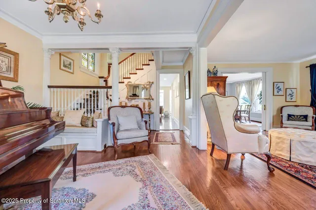 a dining room with furniture potted plants and wooden floor