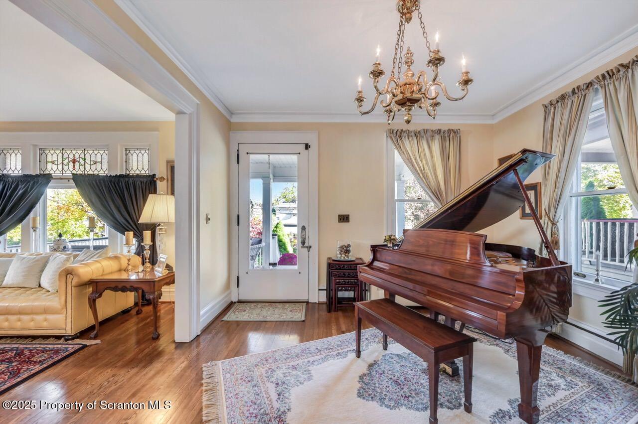 1118 Columbia Street Scranton, PA 18509 - Photo 18 of 92 a living room with furniture a piano and a chandelier