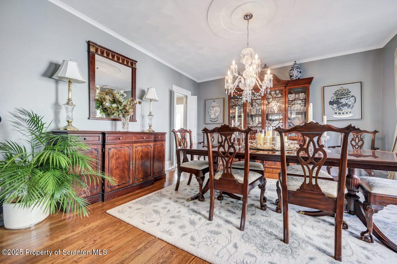 1118 Columbia Street Scranton, PA 18509 - Photo 25 of 92 a dining room with furniture potted plants and wooden floor
