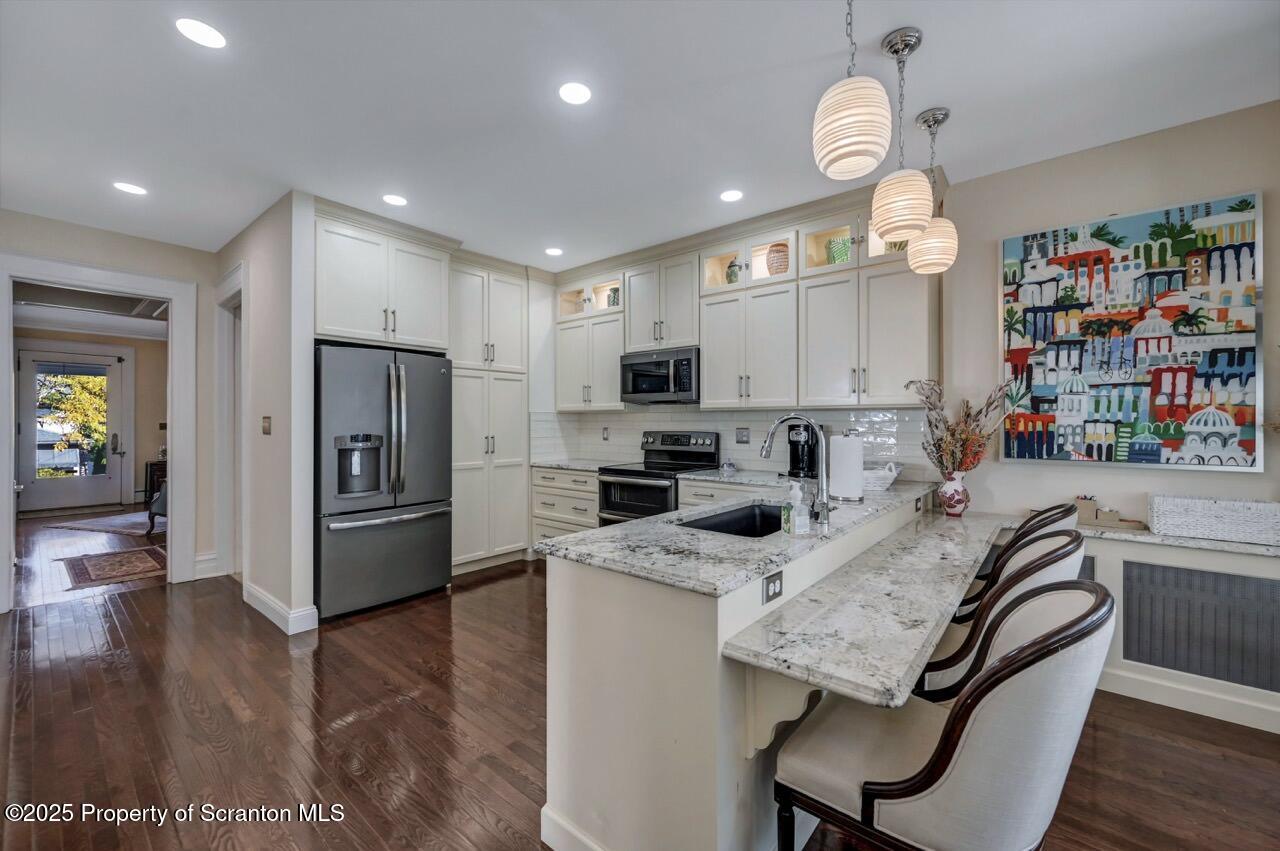 1118 Columbia Street Scranton, PA 18509 - Photo 29 of 92 a kitchen with refrigerator a microwave and cabinets