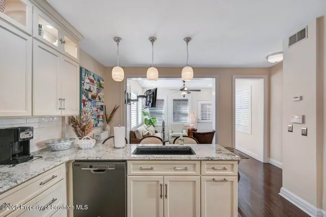 a bathroom with a granite countertop sink a mirror and a window