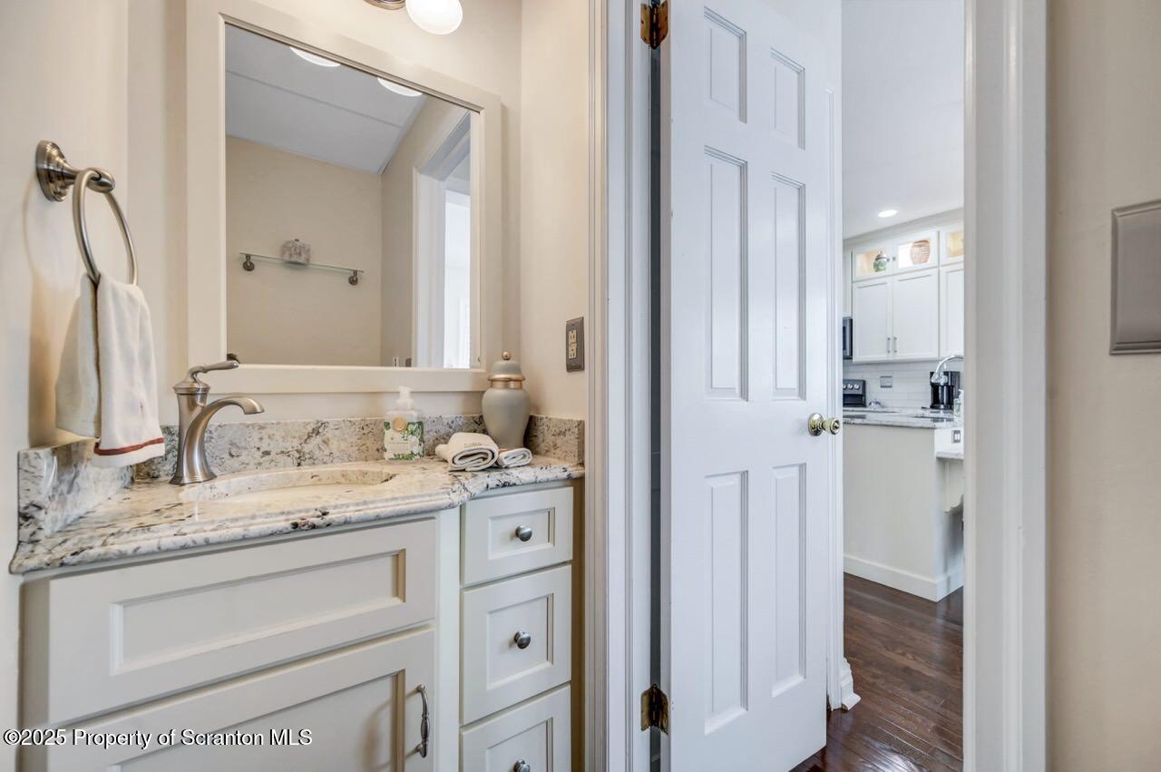 1118 Columbia Street Scranton, PA 18509 - Photo 37 of 92 a bathroom with a granite countertop sink and a mirror