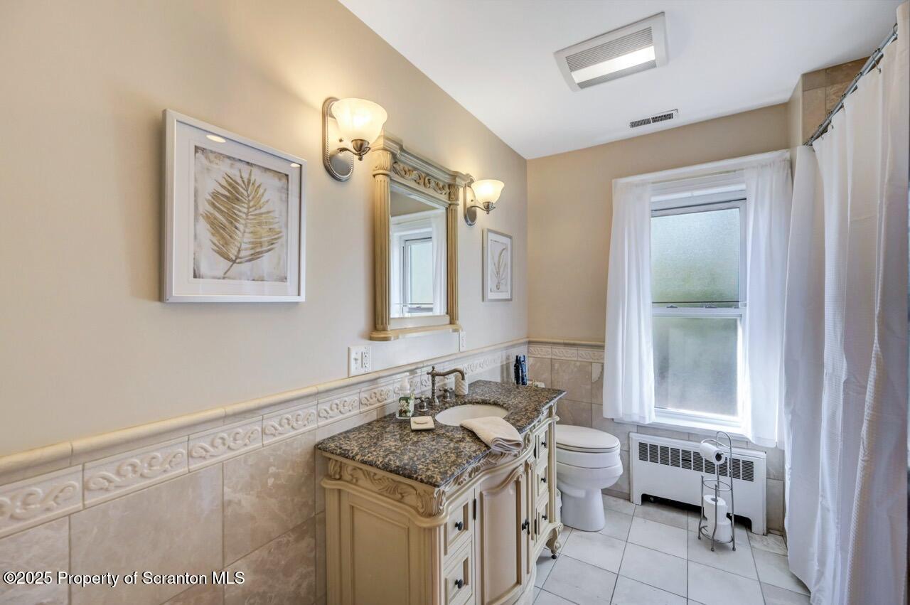 1118 Columbia Street Scranton, PA 18509 - Photo 60 of 92 a bathroom with a granite countertop sink a mirror and a window