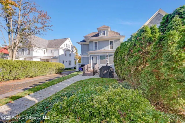 a work room with furniture a piano and wooden floor