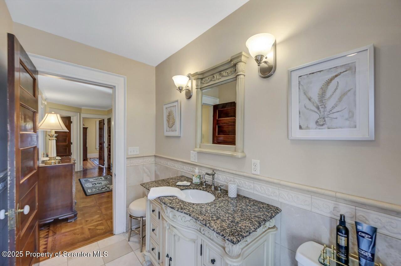 1118 Columbia Street Scranton, PA 18509 - Photo 61 of 92 a bathroom with a granite countertop sink and a mirror
